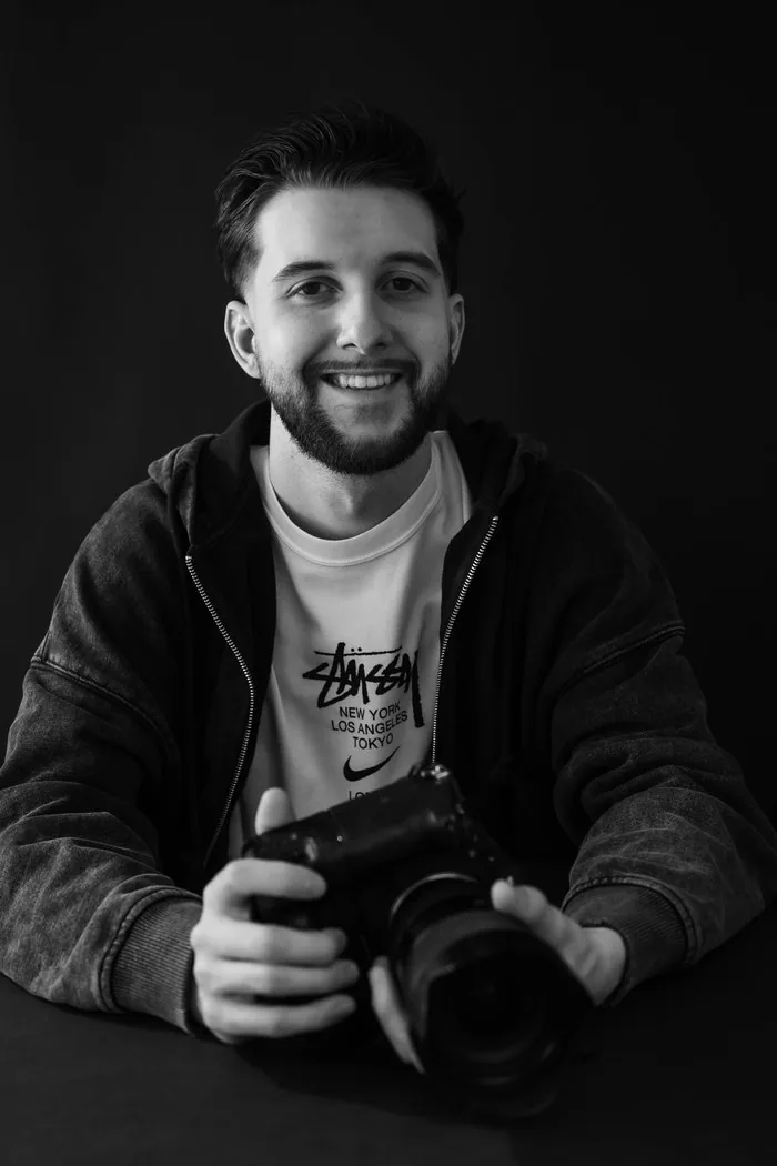 Photographer Josh Graz seated with his camera