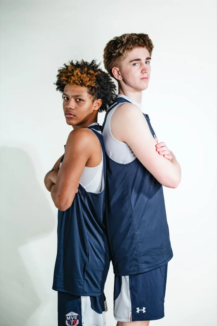Two MVE teammates standing back to back with arms folded at 2026 Media Day